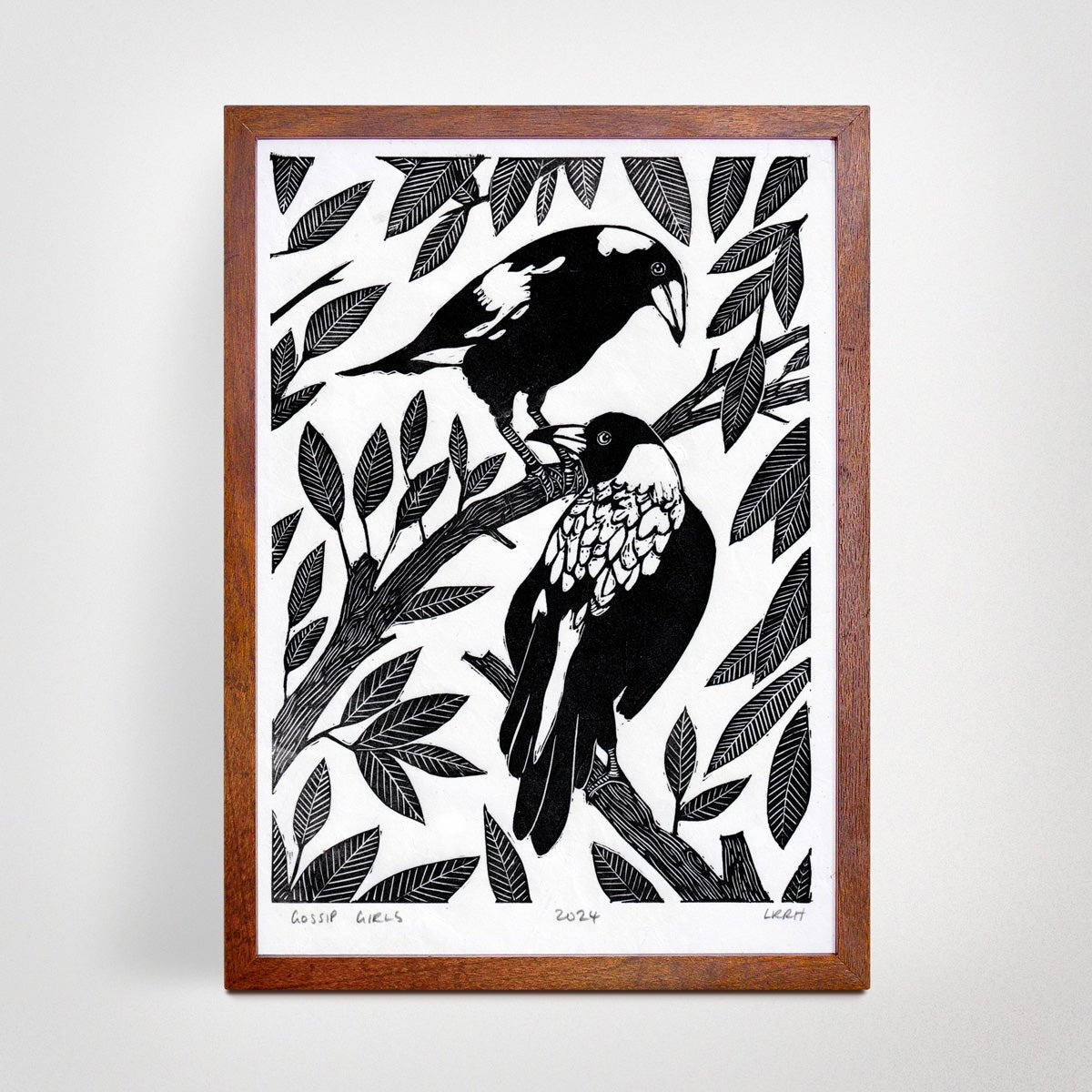 Framed black and white linoprint artwork featuring two Australian magpies.