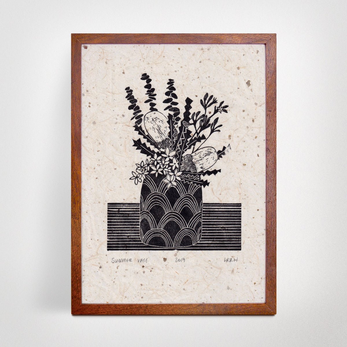 Framed linoprint artwork featuring a still life of a vase containing Australian flowers.