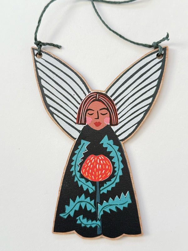Wooden Christmas fairy ornament strung with hemp cord featuring a banksia design. Made in Australia, available for wholesale. 