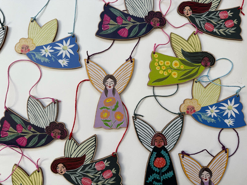 Wooden Christmas Fairy Ornaments featuring native floral designs, strung with hemp cord, made in Australia and available to wholesale. 