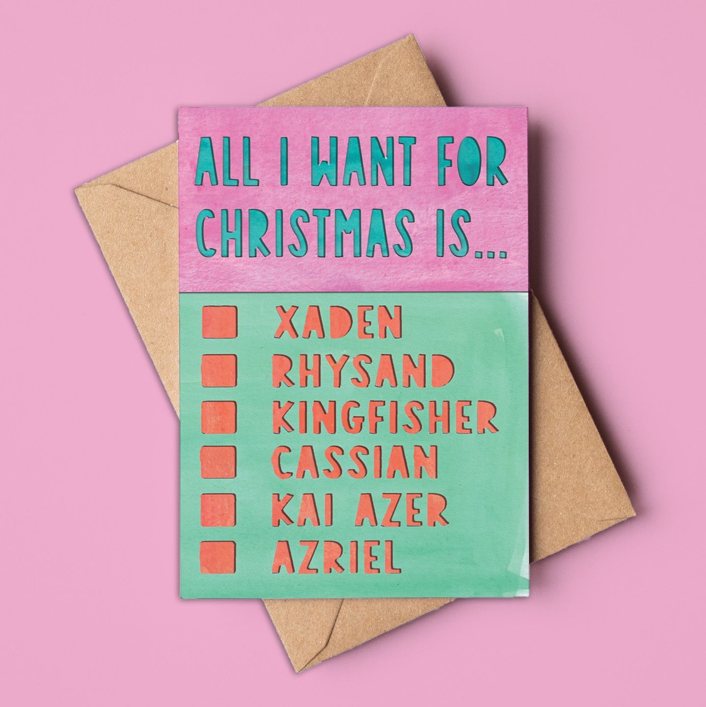A6 pink and green Christmas card with the text “All I Want for Christmas Is…” and a checklist of fictional characters: Xaden, Rhysand, Kingfisher, Cassian, Kai Azer, Azriel. Includes kraft envelope. Made in Australia, wholesale available.