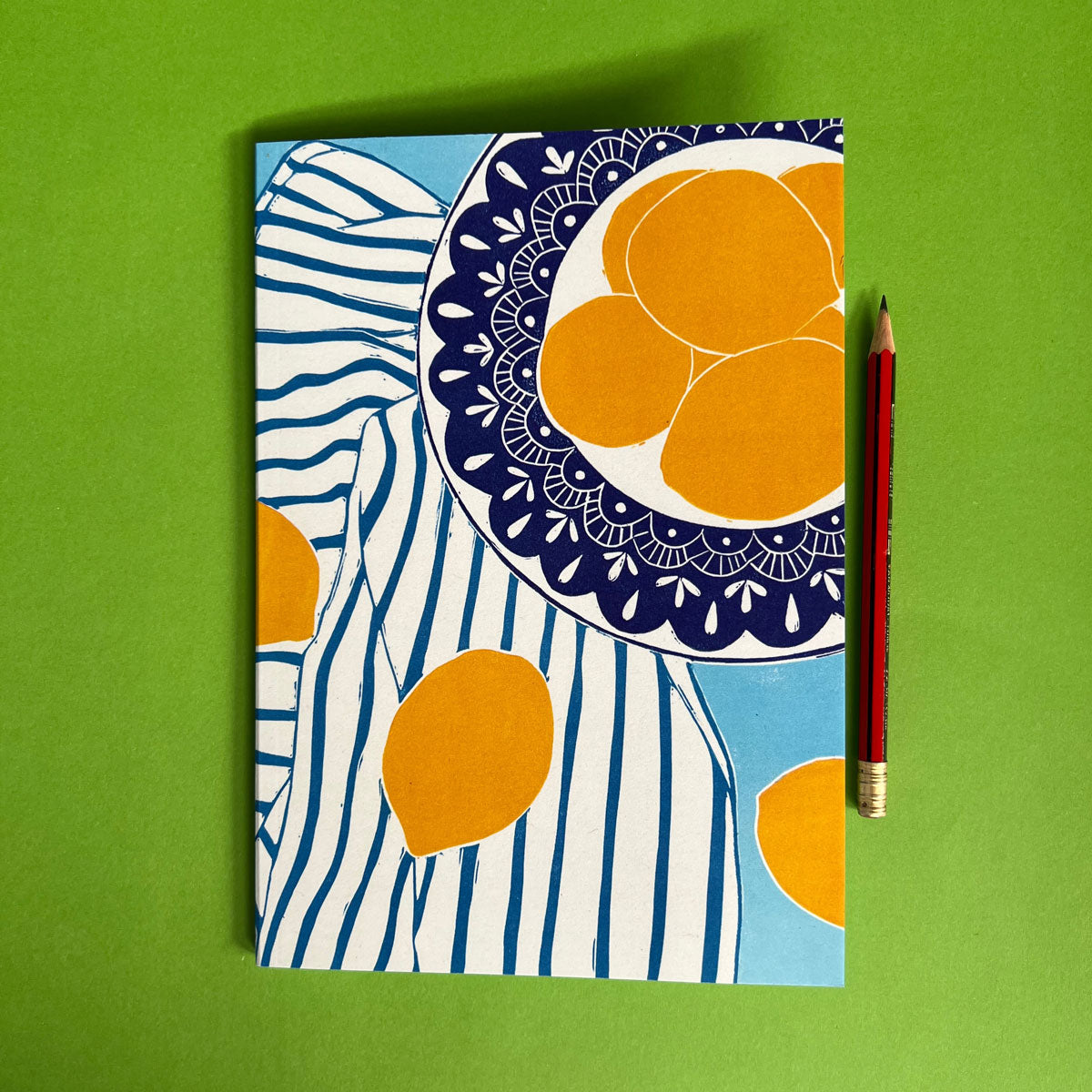 Bold and colourful lined notebook featuring lemons on a blue background, stationery made by Australia