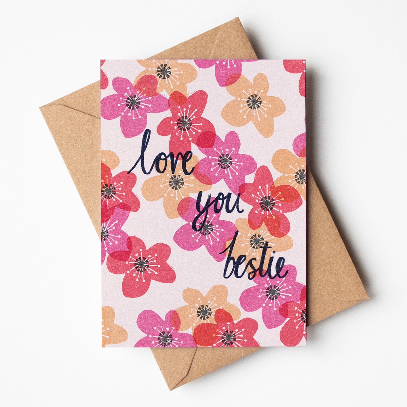 Greeting card with bold pink and red linoprint design that reads “Love You Bestie,” printed on recycled paper in Australia, available for wholesale.