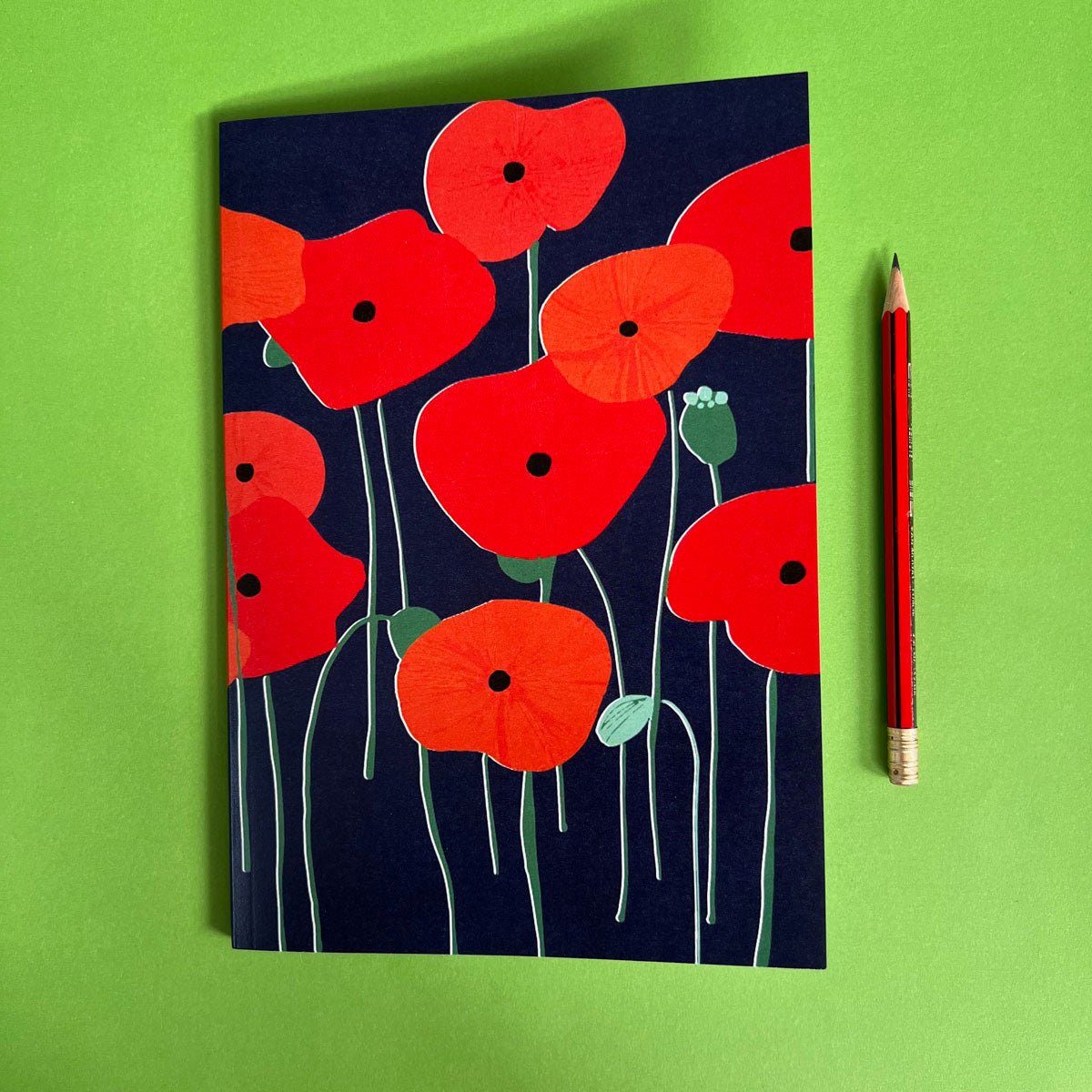 Lined notebook featuring red poppies on a navy background, stationery made by Australia