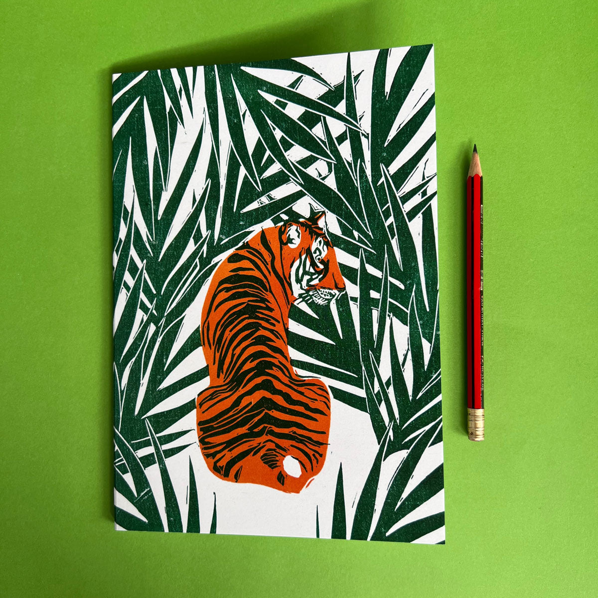 Colourful lined notebook featuring an orange tiger in the green jungle, stationery made by Australia